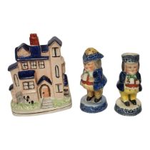 A LATE VICTORIAN STAFFORDSHIRE NOVELTY POTTERY MONEY BOX MODELLED AS A HOUSE Two Victorian