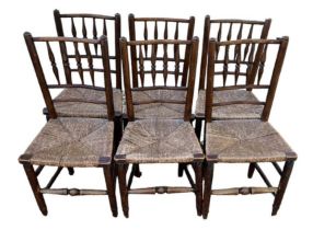 A SET OF SIX 19TH CENTURY NORTH COUNTRY OAK AND ELM RUSH SEATED DINING CHAIRS With turned spindles