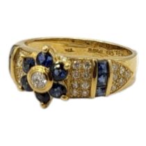 AN 18CT GOLD, DIAMOND AND SAPPHIRE RING The central round cut diamond,edged with sapphires flanked