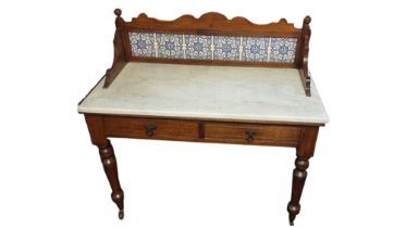 AN EDWARDIAN SATIN WALNUT WASHSTAND With a tiled back and white marble top. (w 112cm x d 53cm x h