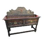 A 19TH CENTURY HEAVILY CARVED OAK SIDEBOARD In Jacobean style, with shaped backboard above two