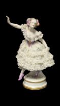AN EARLY 20TH CENTURY RUDOLSTADT VOLKSTEDT OF THURINGIA HARD PASTE PORCELAIN OF A BALLERINA, CIRCA