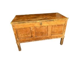 A 19TH CENTURY PINE THREE PANELLED COFFER With internal candle box, raised on stile feet. (96cm x