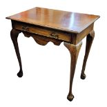 A GEORGIAN STYLE MAHOGANY SIDE TABLE The single drawer above a shaped apron, raised on the shell,