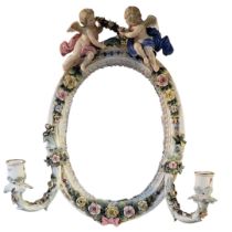 AN EARLY 20TH CENTURY GERMAN PORCELAIN FIGURAL OVAL WALL MIRROR Having a pair of classical angels to