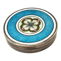 AN EARLY 20TH CENTURY SILVER AND GUILLOCHÉ ENAMEL CIRCULAR PILL BOX With central floral cartouche