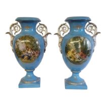 A PAIR OF CONTINENTAL POTTERY VASES Twin scrolled handles with gilt decoration,the central oval