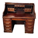 AN EARLY 20TH CENTURY MAHOGANY TAMBOUR 'S' SHAPED ROLL TOP DESK With fitted interior above an