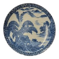 A 19TH CENTURY JAPANESE ARITA BLUE AND WHITE PORCELAIN CHARGER Decorated with figures wearing period