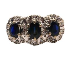 AN 18CT YELLOW AND WHITE GOLD, DIAMOND AND SAPPHIRE RING, HALLMARKED LONDON, 1978 Having three