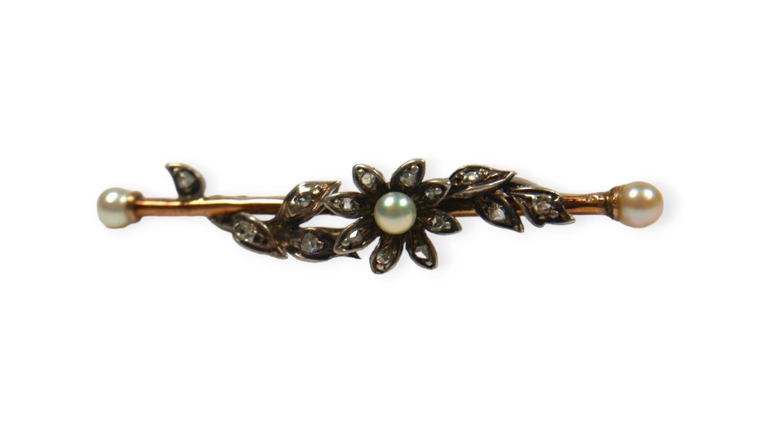 A VICTORIAN DIAMOND AND PEARL FLOWER BAR BROOCH Unmarked gold and silver set with rose cut and rough