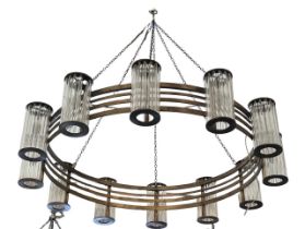 A LARGE ART DECO DESIGN TWELVE LIGHT BRASS AND GLASS CIRCULAR CHANDELIER. (drop 107cm x diameter