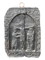 A 19TH CENTURY CARVED BLACK OAK CARVED PANEL DEPICTING THE CRUCIFIXION IN DEEP RELIEF. (41.5cm x