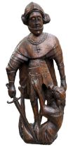 A 15TH CENTURY GERMAN CARVED WALNUT STATUE OF ST. MICHAEL’S DRAGON. (h 94cm) Provenance: private