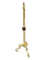 A FRENCH ORMOLU AND GILT METAL FLOORSTANDING LAMP With porcelain acorn decoration, raised on three