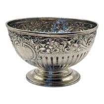 A GEORGIAN SILVER SUGAR BASIN Having embossed scrolled decoration with flutes and stepped circular