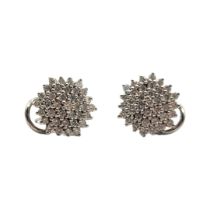 A PAIR OF 9CT WHITE GOLD DIAMOND CLUSTER EARRINGS Having an arrangement of diamonds forming an
