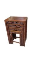 AN EARLY 20TH CENTURY CHINESE HARDWOOD NEST OF TABLE FOUR TABLES Hand carved with opposing dragons