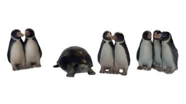 ROYAL COPENHAGEN, A COLLECTION OF FOUR VINTAGE DANISH PORCELAIN ANIMAL FIGURES Three penguin group