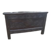 AN 18TH CENTURY CARVED OAK COFFER The central panel with crown contained in shield. (96cm x 47cm x
