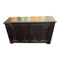 A 19TH CENTURY OAK COFFER The four panelled front carved with medieval figures, flanked by reeded
