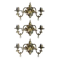 A SET OF THREE 20TH CENTURY DUTCH STYLE GILT BRASS TWO BRANCH WALL SCONCES Cast with foliate