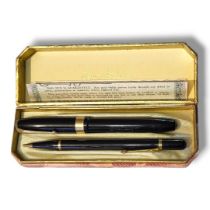 CONWAY STEWART, A VINTAGE FOUNTAIN PEN AND PROPELLING PENCIL SET Gold plated mounts, pen marked ‘