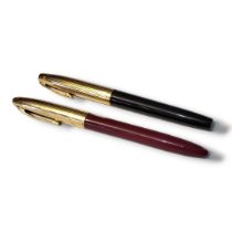 SCHAEFFER, TWO VINTAGE FOUNTAIN PENS Having gold plated mounts, black and burgundy case and 14ct