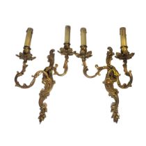 A PAIR OF 20TH CENTURY GILT BRASS WALL SCONCES Twin branch with fabric shades and rococo scrolls