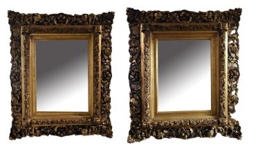 A PAIR OF 19TH CENTURY STYLE GILT FRAMED MIRRORS With acanthus carved corners centred with