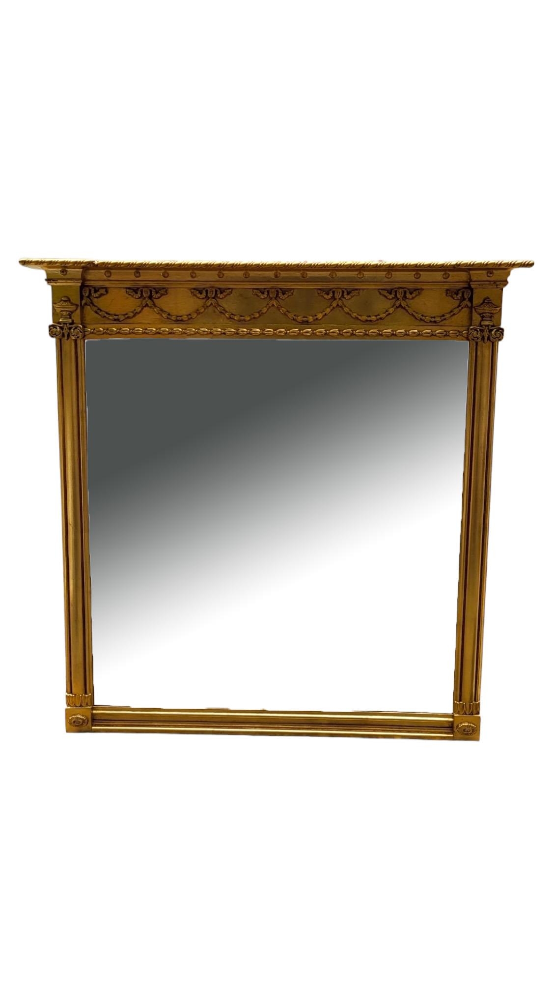 A LARGE 18TH CENTURY STYLE GILT FRAMED MIRROR With Adam swags and urns above a bevelled plate