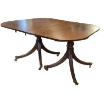 A REGENCY PERIOD SOLID MAHOGANY TWIN PILLAR D END EXTENDING DINING TABLE With two extra leaves,