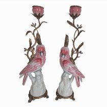 A PAIR OF CONTINENTAL FIGURAL BRONZE AND CERAMIC CANDLESTICKS The single sconces above seated
