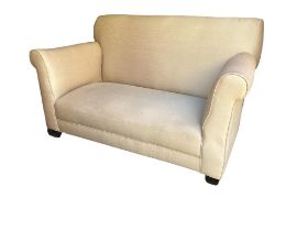 AN EDWARDIAN SINGLE DROP END TWO SEAT SETTEE In recent cream fabric upholstery, on squat tapering