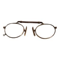 A PAIR OF VICTORIAN GOLD PLATED PINCE NEZ OVAL SPECTACLES With spring frame. (approx 10cm)