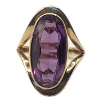 A VINTAGE 9CT GOLD AND AMETHYST RING The oval cut stone in a pierced mount. (size N) Condition: good