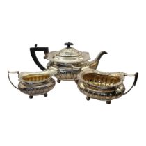 AN EARLY 20TH CENTURY SILVER TEA SET Three piece comprising a teapot, twin handled sugar basin and