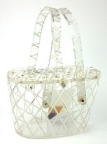 A VINTAGE LUCITE AND RHINESTONE HANDBAG Twin carry handles, set with twenty-two rhinestones within a