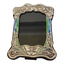 AN ART NOUVEAU STYLE PICTURE FRAME With enamel and floral embossed metal facade on a wooden easel