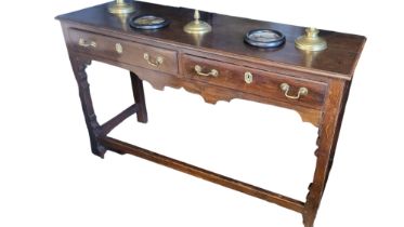 A GEORGE III PERIOD OAK DRESSER The two drawers fitted with brass escutcheons and handles above a