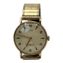 VERTEX, A MID CENTURY 9CT GOLD GENT’S WRISTWATCH Having Arabic quarter number makings and subsidiary