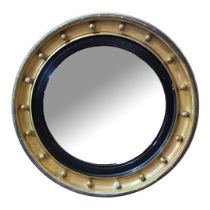 A LARGE REGENCY PERIOD GILT FRAMED CONVEX MIRROR With ebonised slip. (64cm) Condition: some gilt