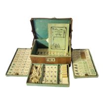 AN EARLY 20TH CENTURY BONE AND BAMBOO MAHJONG SET Over 150 characters in three fitted pull out trays