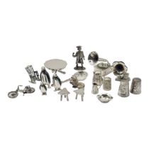 A COLLECTION OF CONTINENTAL SILVER AND WHITE METAL MINIATURE TRINKETS Comprising a town crier,