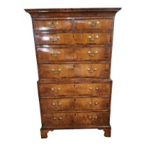 AN 18TH CENTURY WALNUT CHEST ON CHEST The deep cushion cornice above two short and six long