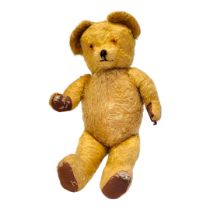 A VINTAGE GOLD MOHAIR TEDDY BEAR Amber glass eyes and stitched black nose. (approx 60cm)