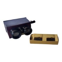 AN EARLY 20TH CENTURY MAHOGANY CASED STEREOSCOPE With glass slides, one slide damaged corners.