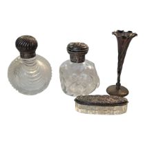 TWO EARLY 20TH CENTURY SILVER AND CUT GLASS SCENT BOTTLES Having embossed decoration to hinged lid