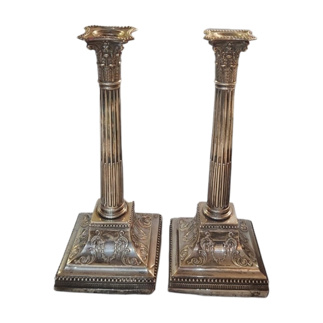 A LARGE PAIR OF LATE 19TH/EARLY 20TH CENTURY SILVER CANDLESTICKS Classical form with reede columns