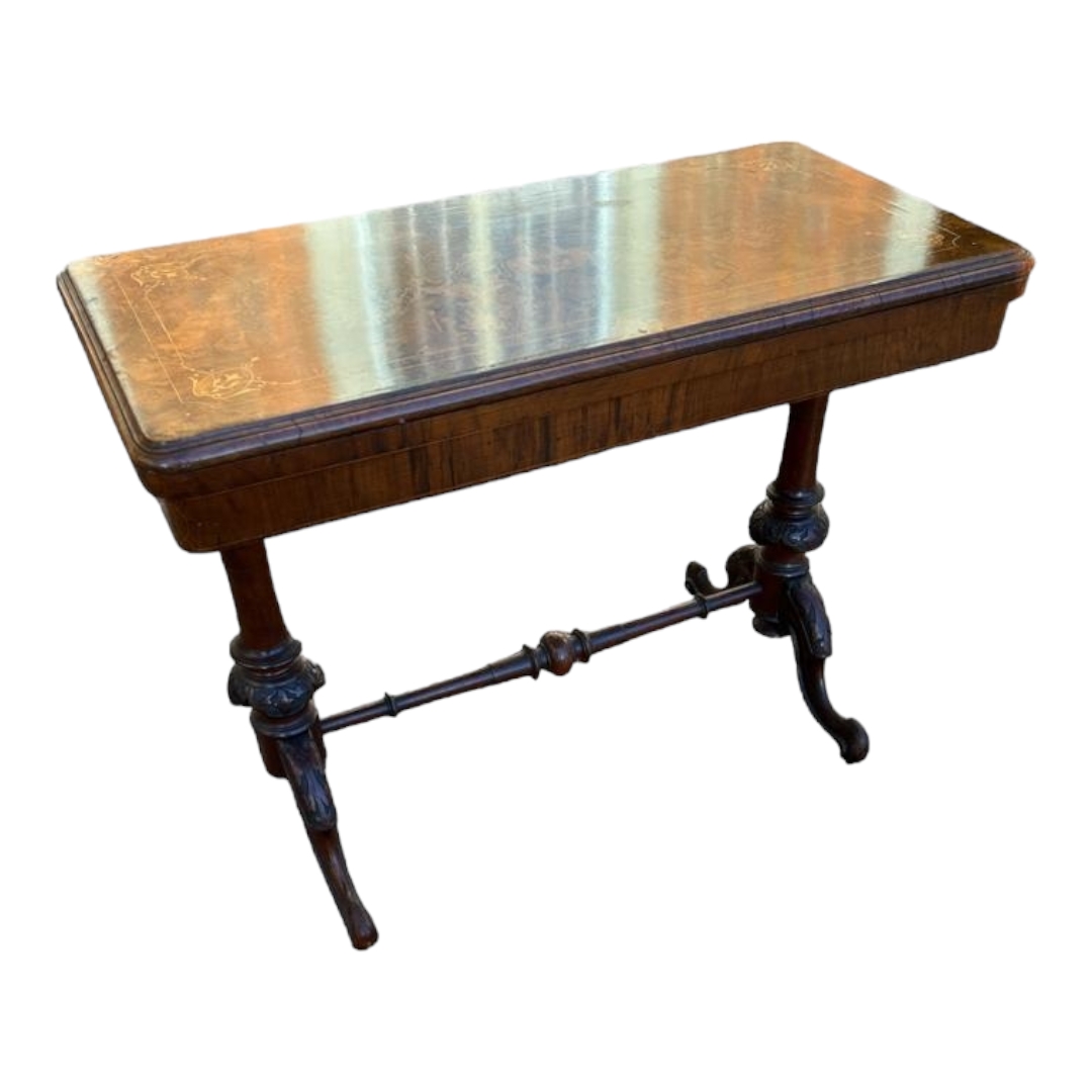 A VICTORIAN FIGURED WALNUT AND MARQUETRY INLAID FOLD OVER CARD TABLE With green baize surface,